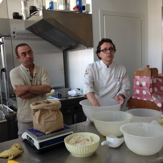 Enzo Marinato at work with the panettone dough, under the observation of his Breton colleague