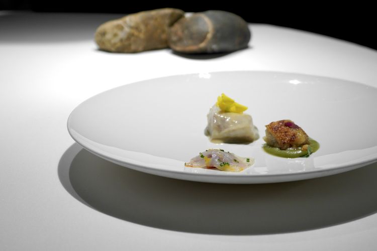 Turbot trilogy: from the bottom, anti-clockwise, carpaccio of marinated turbot with tartare of Kalamata olive, chives, zest of grapefruit and dried tomato; turbot filet with pil pil; grilled turbot with cream of garlic and oxalis flowers
