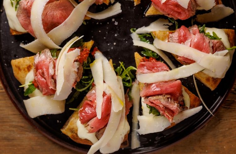 Una pizza di Tommaso Vatti, de La Pergola di Radicondoli (Siena), da sempre attentissimo a celebrare le eccellenze del territorio. Questa pizza &egrave; con rucola, groppa di cinta senese Dop di Simone Fracassi, erba pepe, crumble di pane all&rsquo;olio e fiordilatte
