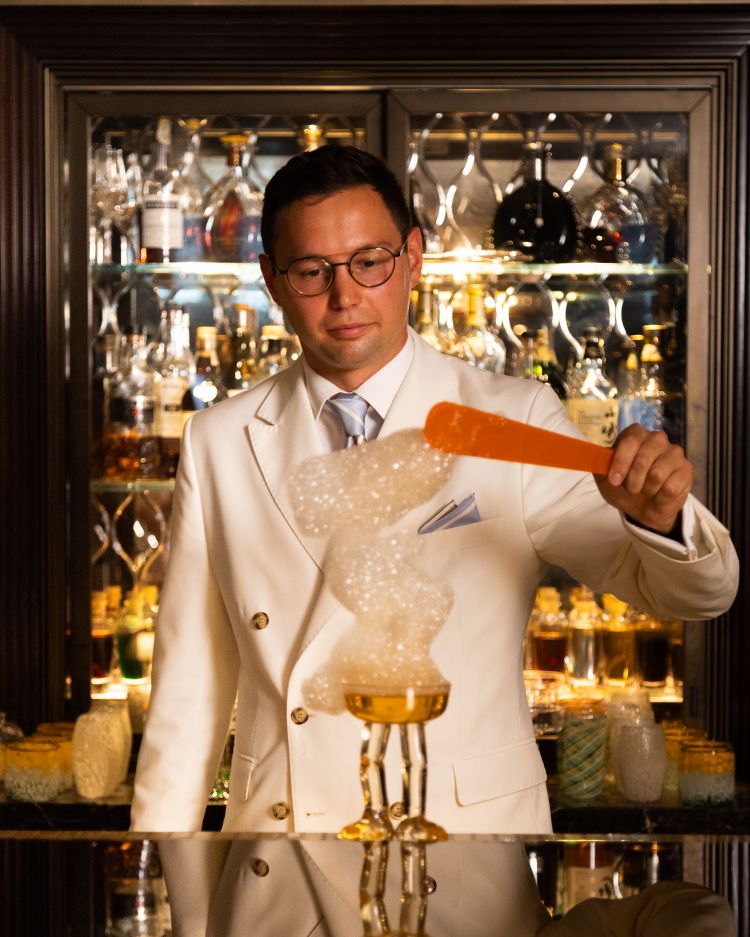 La nuova drinklist dell'Arts Bar non si ferma alla realizzazione di bicchieri, ma la loro preparazione prevede alcune lavorazioni spettacolari come la nuvola d'arancia che Ludwig Negri pone a completamento del drink Still Waiting.