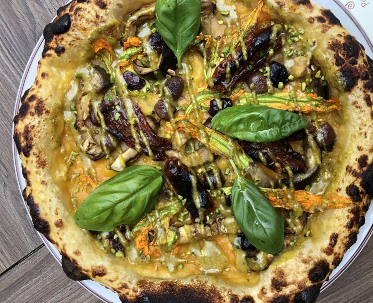 Mani in Pasta's Vegan pizza: yellow date tomato sauce, pistachio cream, grilled aubergine, sun-dried tomato and courgette flower
