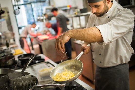 A cook at work in Marta in cucina’s kitchen in Reggio Emilia. Photo by Niccolò Cozzi
