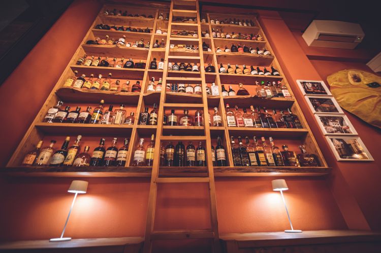 A noteworthy bottle cabinet that boasts a collection of 3000 bottles of distillates between Cachaça, Agricole, Haiti with a particular fondness for white rum