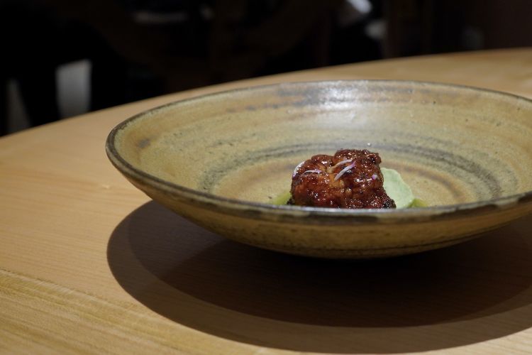 Veal sweetbreads & larch pinecones. The sweetbreads of the heart of veal are cooked with butter in a cast iron pan, on the embers. On the bottom there’s an emulsion of sour herbs, paired with the water of fermentation of the larch pinecones. Very good