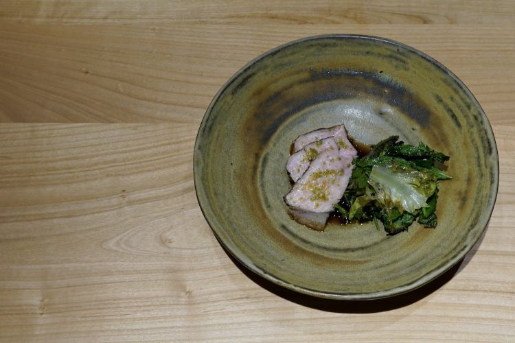 Vitello dei nostri masi The veal loin is cooked at low temperature on the embers and paired with sour herbs and a mountain herb salad (dandelion, baby lettuce, baby spinach, home-made balsamic vinegar)