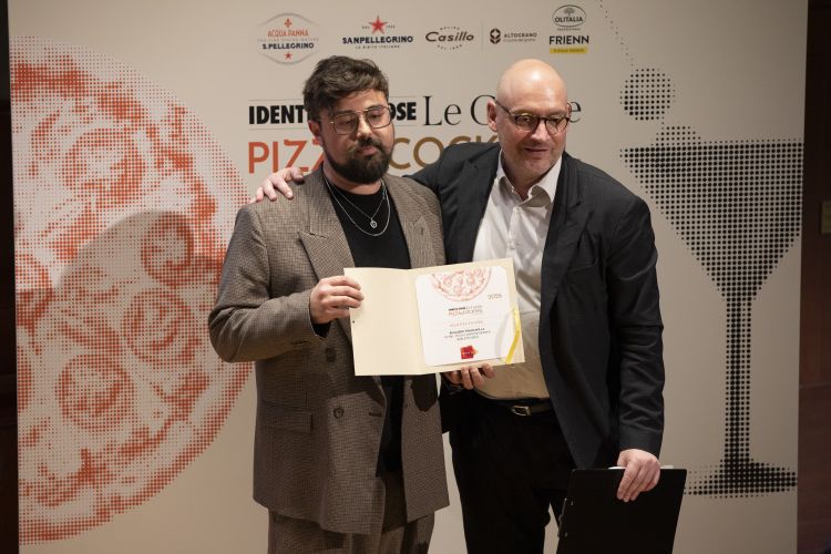 Ruggiero Francavilla conquista il premio Identit&agrave; Future alla presentazione della terza edizione della Guida di Identit&agrave; Golose alle Pizzerie & Cocktail Bar d'autore 2026. Con lui &egrave; Carlo Passera, curatore "lato pizza" della Guida stessa
