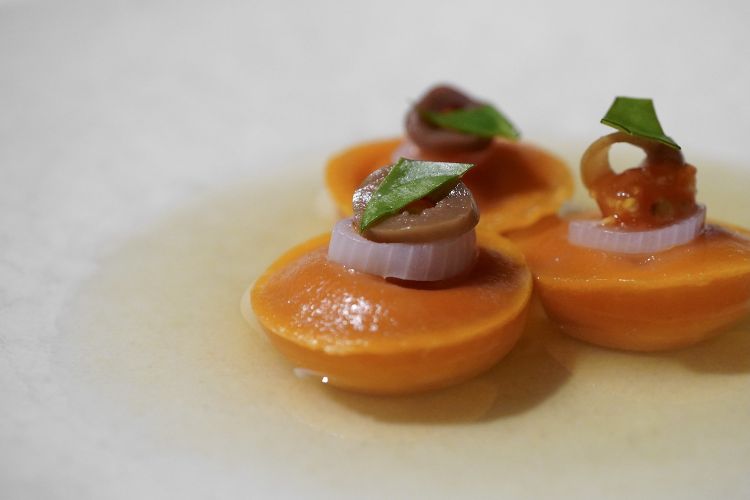 Insalata di pomodoro: bottoni ripieni di pomodoro liquido, cipolle, olio, basilico