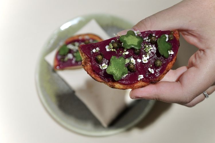 Beetroot pizza (in sauce and sliced), garlic, oil, salt, fried capers and sedum telepium 
