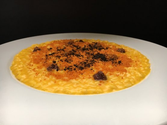 The Risotto with pumpkin from Mantua, earth of olives and 'nduja prepared last Friday at Coin by Cesare Battisti, chef at Ratanà in Milan

