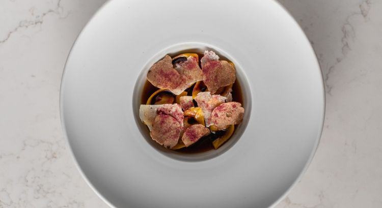 Tortelli ripieni di genovese, brodo di cipolla rossa ossidato, gel di arancia e cacao al ristorante I Portici

