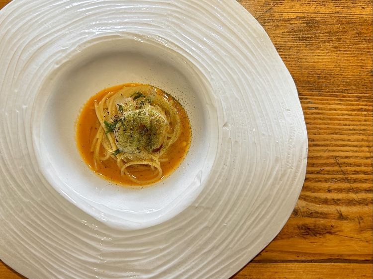 Spaghettino Felicetti in estratto di granchio blu, salsa di gamberi, gambero marinato tiepido, polvere di limone nero e cipolla a La Saletta di Alghero
