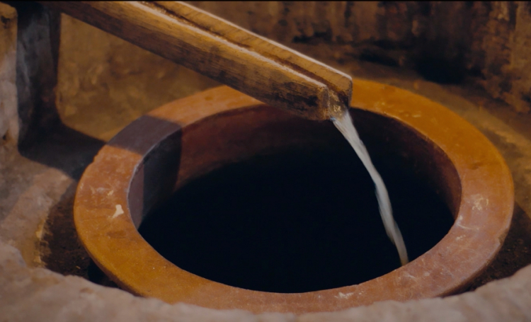 Wine goes inside a buried amphora 
