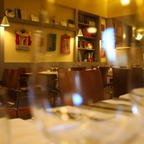 The dining room of Timè seen through a glass